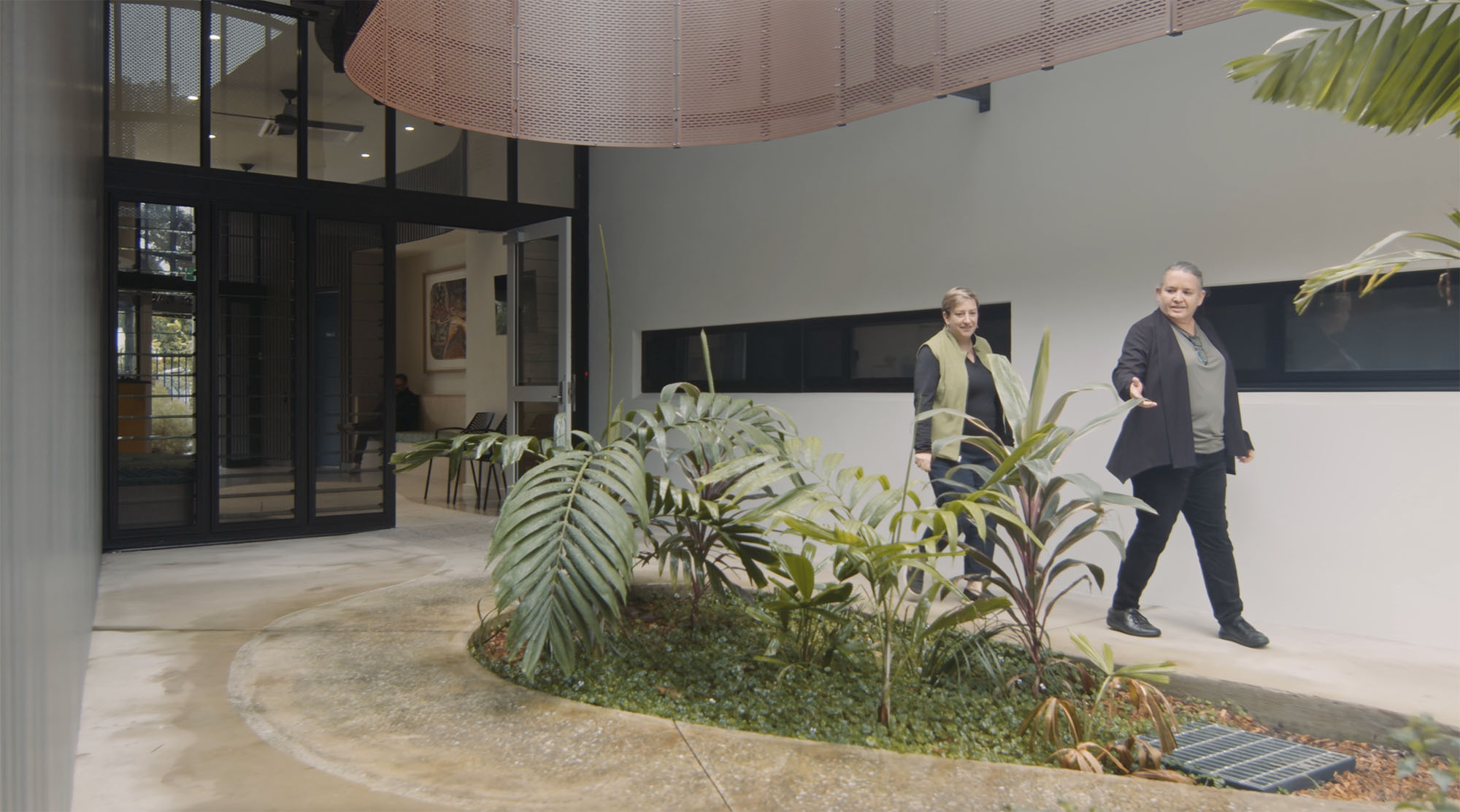 female architects walking in outdoor courtyard