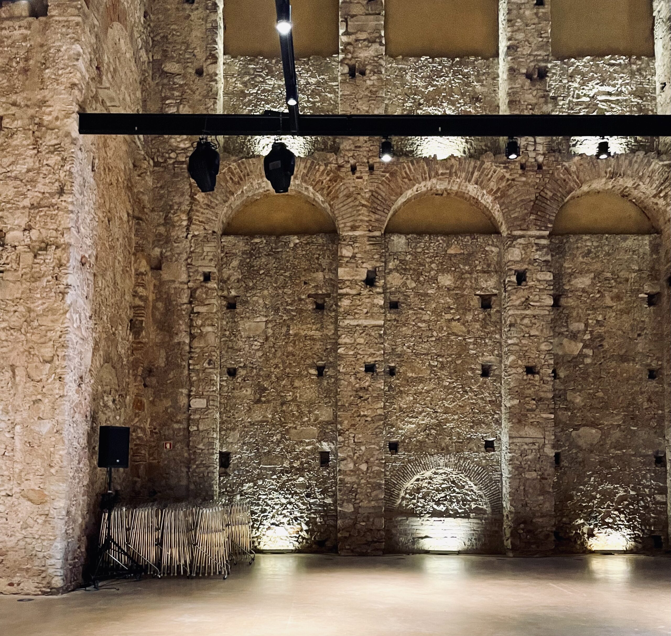 Yellow tinted concrete walls stabilise the 1840s stonewalls. Careful insertions illuminate the ruins and provide services to enable performances.