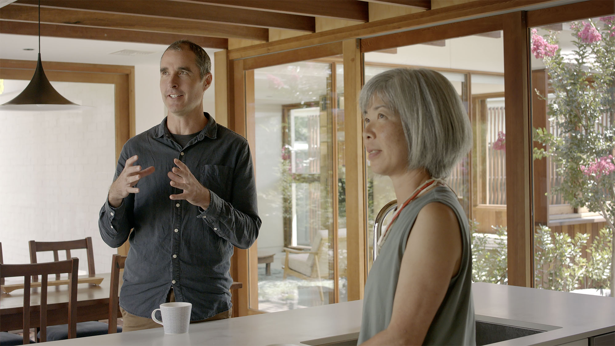 Anthony in discussion in kitchen with Hiroko