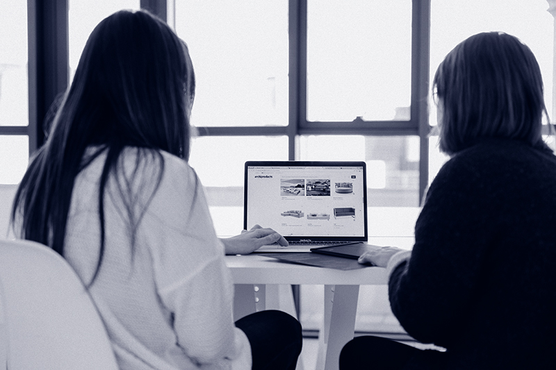 Two people looking at a laptop