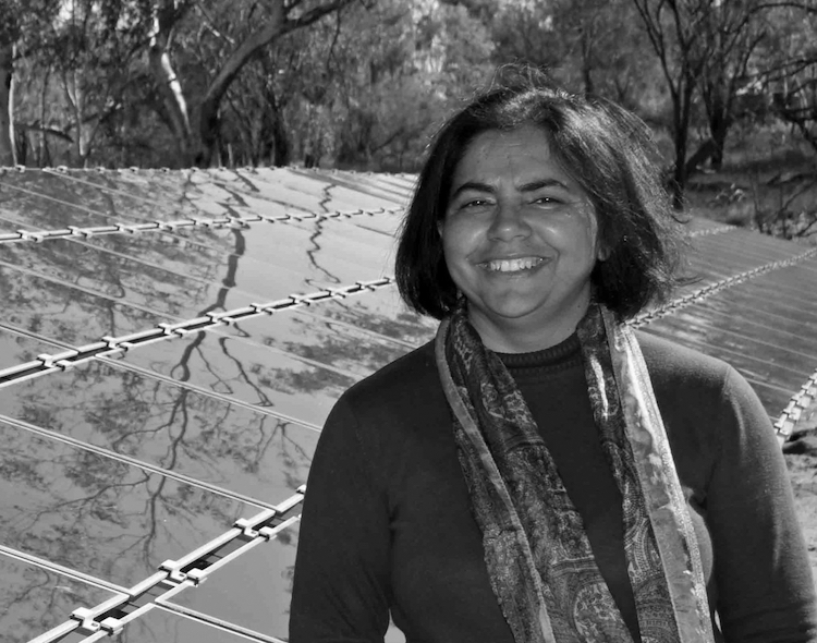 Headshot of Dr Deepika Mathur, solar panels in the background